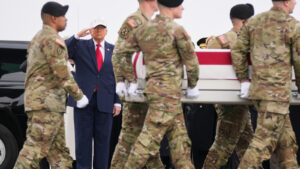 President Donald Trump grieves with families during return of soldiers killed in war in the Middle East